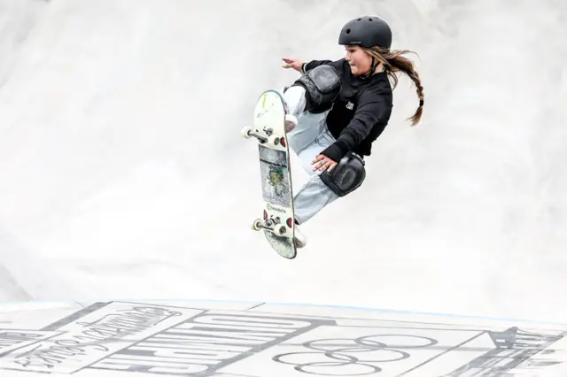 Sky Brown doing a trick in the air on her skateboard