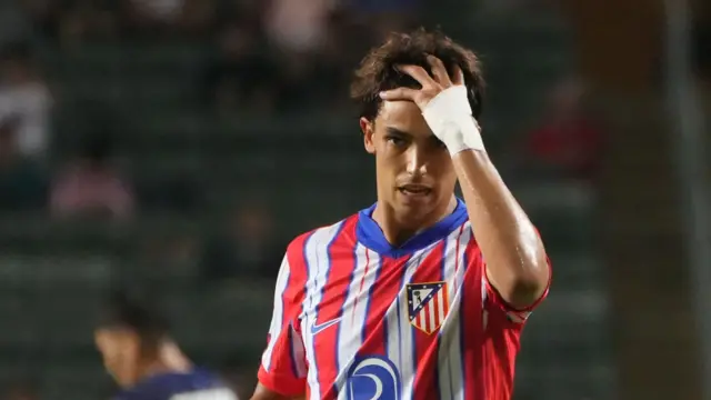 Joao Felix with his hand to his head while playing in a pre-season friendly for Atletico Madrid