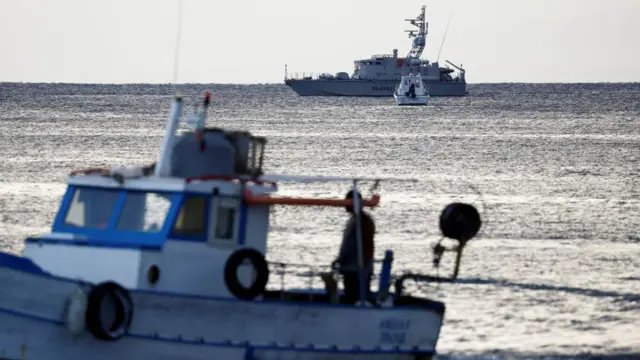 Two coast guard ships out on the water in early morning light