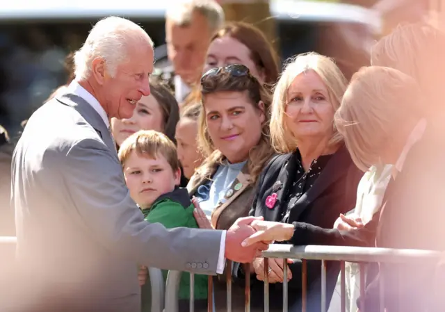 King Charles III shakes hands with a wellwisher as he departs Southport Town Hall