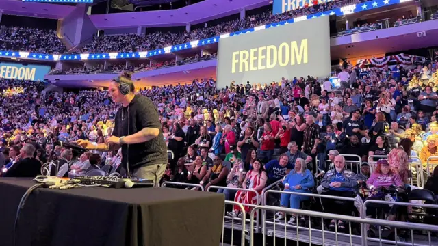 A DJ plays in front of a crowd