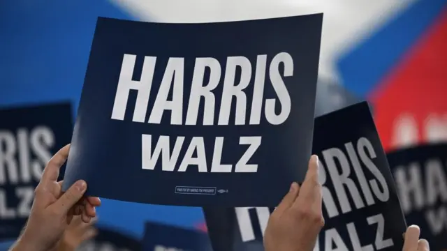 Supporters of Democratic presidential candidate and U.S. Vice President Kamala Harris and her vice presidential running mate Minnesota Governor Tim Walz hold signs, as Harris and Walz are about to make a four-stop bus tour of western Pennsylvania before heading to Chicago for the Democratic National Convention, in Pittsburgh, Pennsylvania, U.S., August 18, 2024.