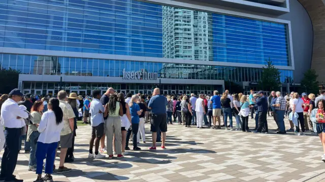 People queue outside a conference centre