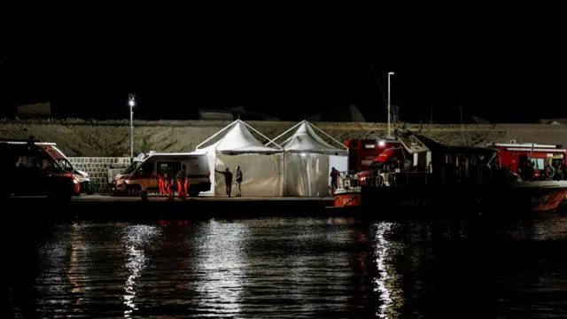 Emergency and rescue service officials continued working at a port near the site where a luxury yacht sank well into the evening on Tuesday