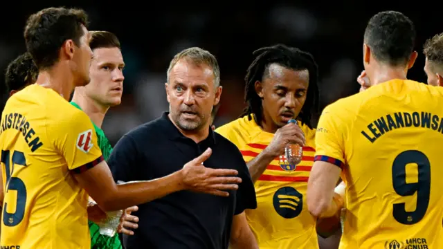 Barcelona coach Hansi Flick speaking to his players during their game against Valencia