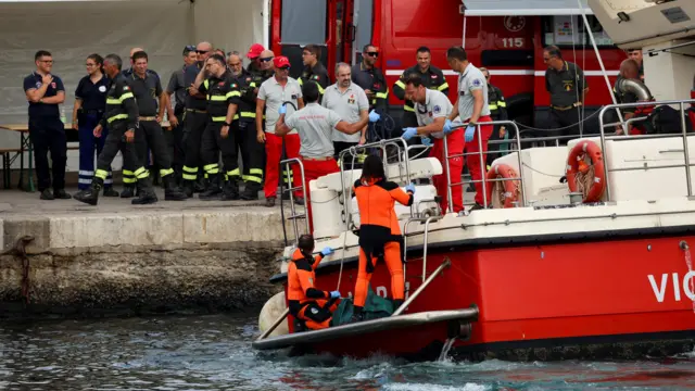 Rescue personnel transport a body bag