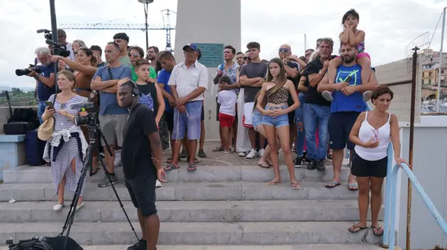 Crowds watching on from across the harbour