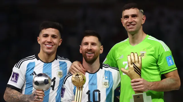 Enzo Fernandez, Lionel Messi and Emiliano Martinez with awards after helping Argentina win the 2022 World Cup