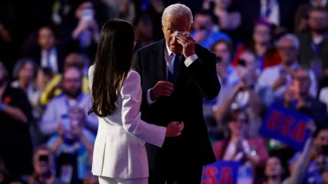 US President Joe Biden wipes away a tear after his daughter introduced him on stage on the first night of the convention