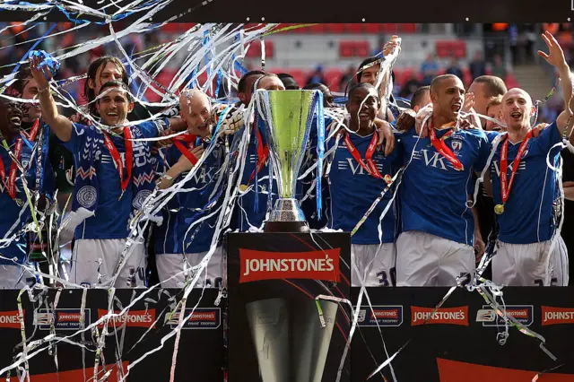 The Chesterfield team celebrate with the trophy after winning the Johnstone's Paint trophy Final at Wembley Stadium