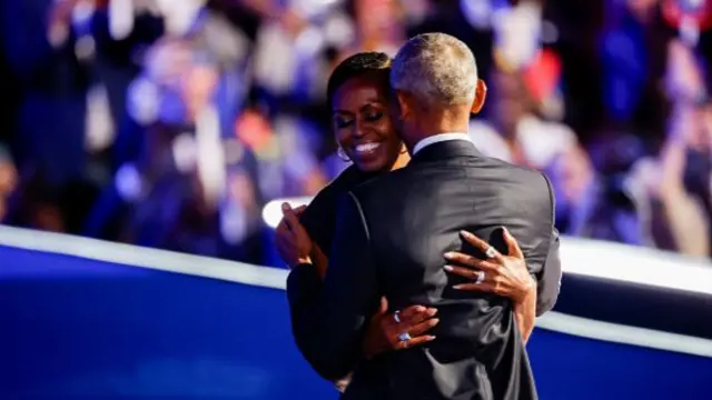 Michelle and Barack Obama hug at the DNC