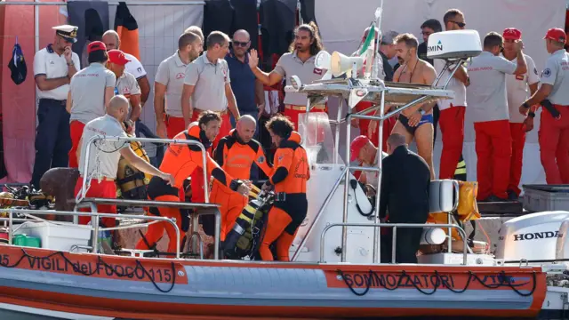 Rescue divers climbing onto a boat