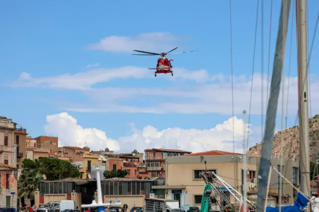 A fire brigade helicopter flying over the port