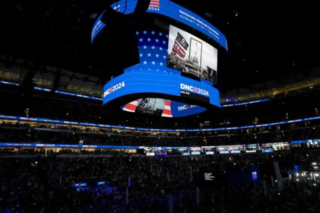 Jan 6 image shown on jumbatron screen above DNC crowd