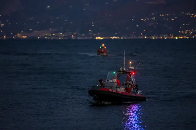 Italian fire brigade boats sail during rescue operation