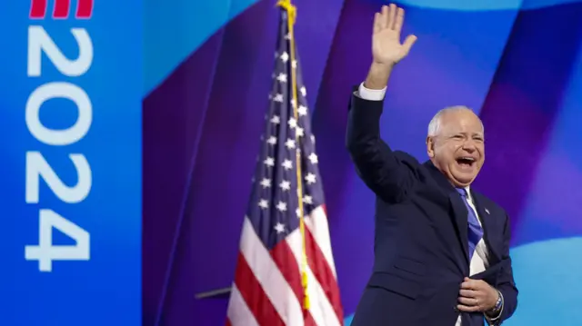 Vice Presidential nominee Tim Walz walks on to the stage at the Democratic National Convention, waving to the crowd