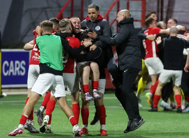 Larne celebrate beating Ballkani in the IInver Park shootout