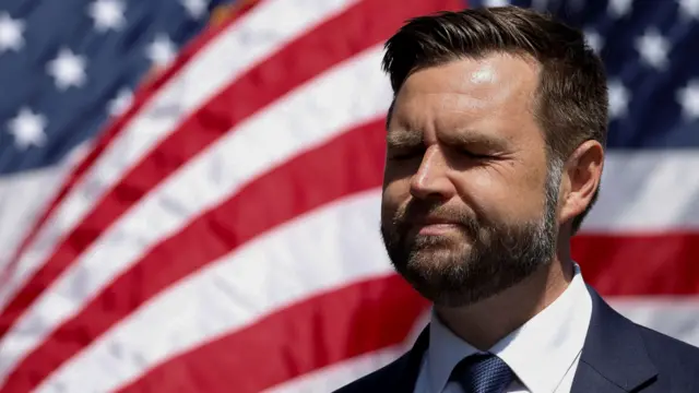 JD Vance stood in front of an American flag