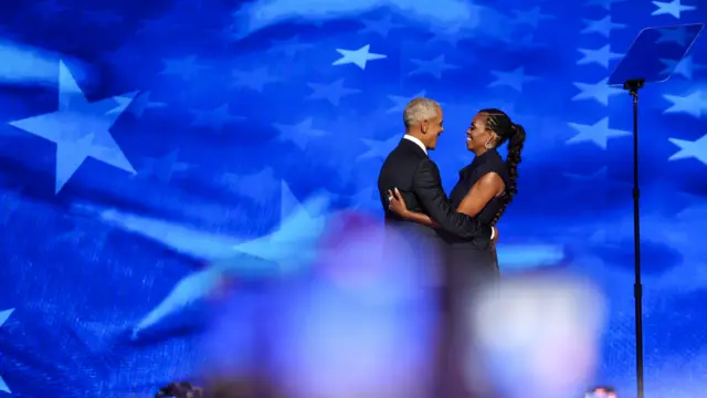 Michelle Obama embraces her husband Barack Obama