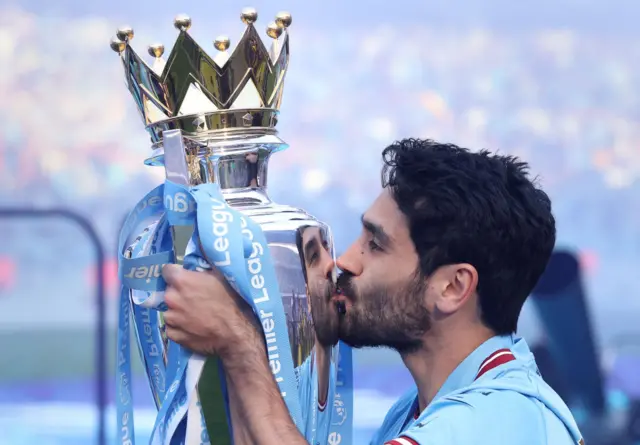 Ilkay Gundogan lifting the Premier League trophy