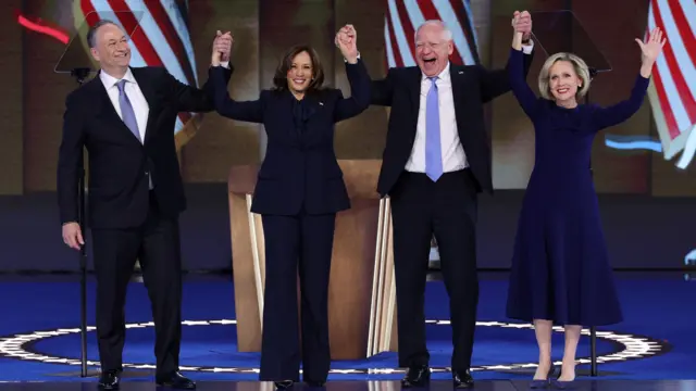 Democratic presidential nominee Kamala Harris celebrates with her husband, second gentleman Doug Emhoff, and vice presidential nominee Minnesota Gov Tim Walz and his wife Gwen.