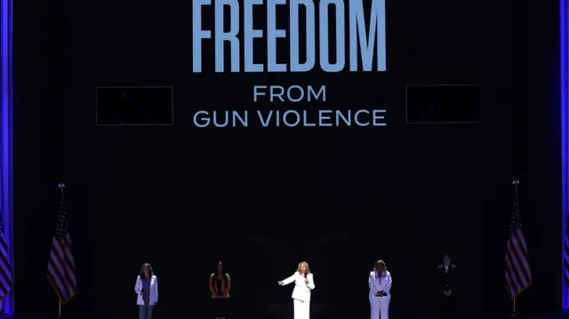 Georgia Democratic Rep. Lucy McBath speaks on stage at the DNC with relatives of gun violence victims