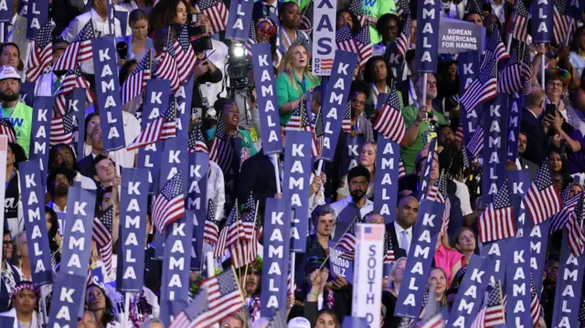 Kamala Harris signs fill the arena as Kamala Harris speaks