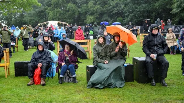 Festivalgoers attend the folk music Toender Festival as the Storm Lilian approaches,