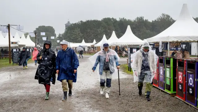 Festivalgoers attend the folk music Toender Festival as the Storm Lilian approaches,