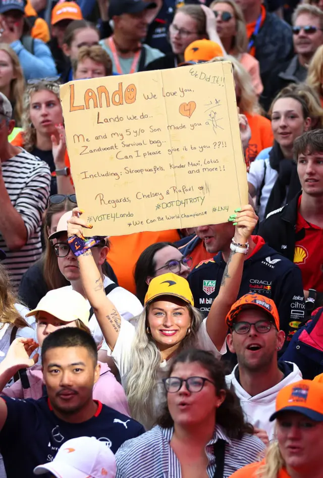 Fans hold signs up for Lando Norris at Zandvoort