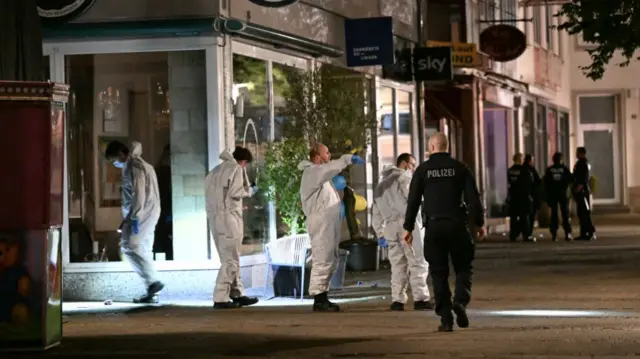 Officers searching outside a restaurant