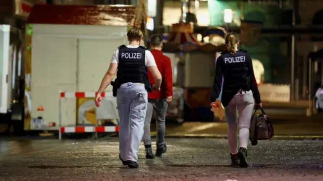 Police officers work following an incident in which several individuals were killed on Friday night when a man randomly stabbed passers-by with a knife, at a city festival in Solingen