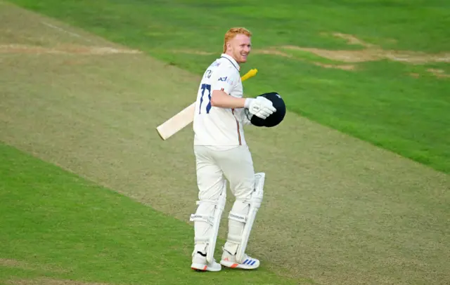 Jordan Cox celebrates his century