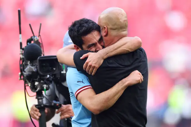 Pep Guardiola hugging Ilkay Gundogan.