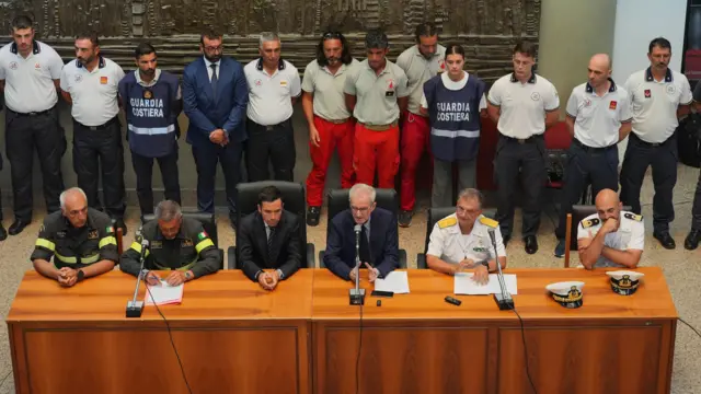 Officials and security forces who took part in the search and rescue operations at a press conference.