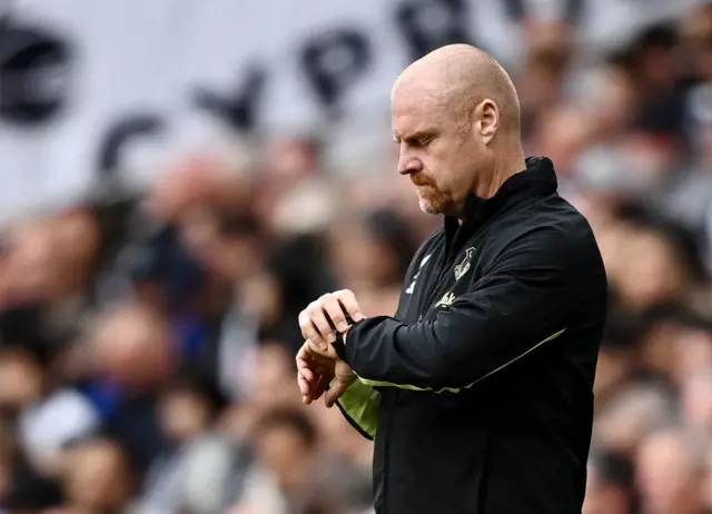 Sean Dyche checks his watch