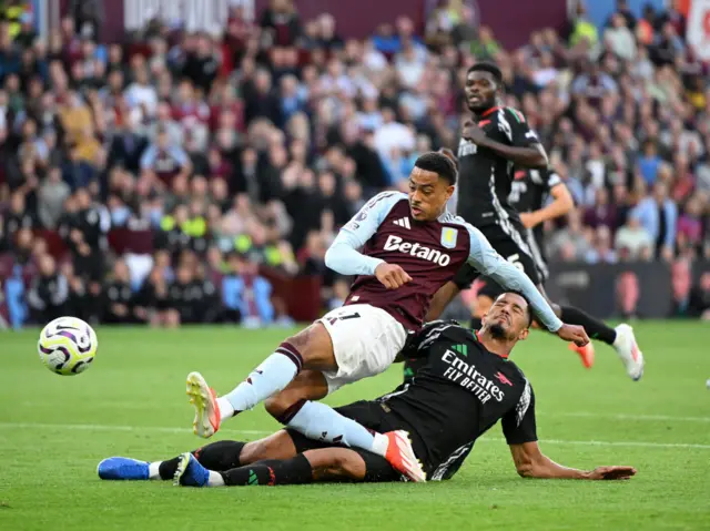 Saliba tackles Ramsey in the box