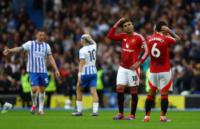 Brighton players celebrate as United players walk around dejected