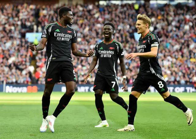 Arsenal players celebrate their second goal