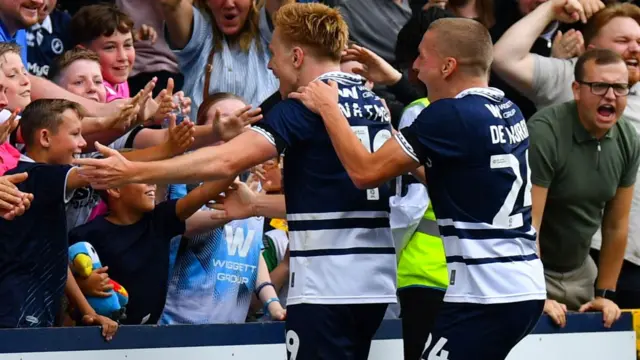 Millwall players celebrate with fans