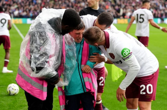 Jarrod Bowen consoles an injured ball boy