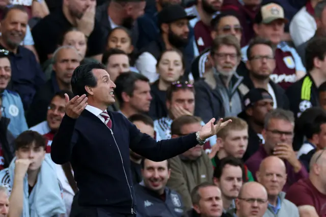 Emery reacts by throwing his arms in the air