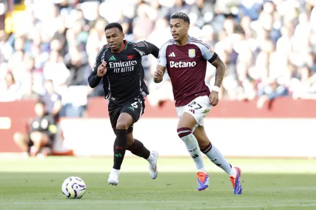 Rogers drives up field with the ball as Gabriel pursues