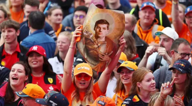 Max Verstappen fans hold up signs