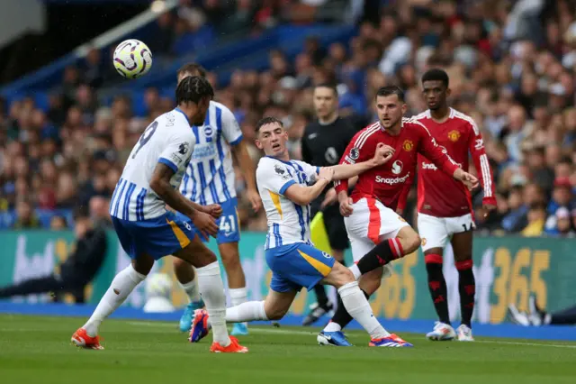 Mount plays the ball forward under pressure from three Brighton players