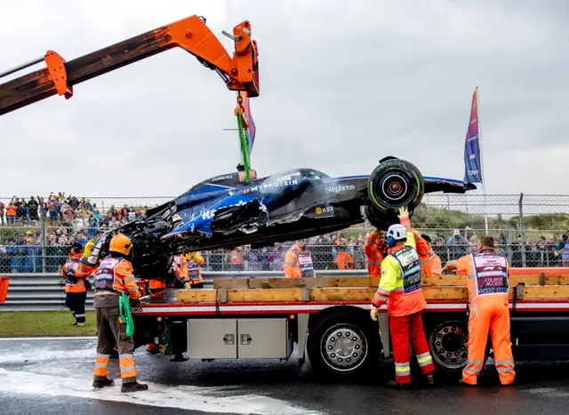 Logan Sargeant's car is lifted onto the recovery truck