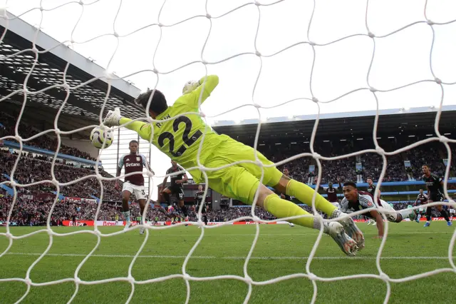 Behind the net view of Raya's save from Watkins