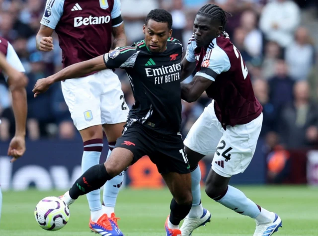 Jurrien Timber in action with Aston Villa's Amadou Onana