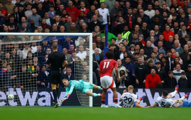 The ball deflects off a defender and into the Brighton net