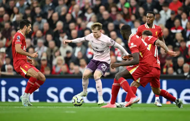 Lewis-Potter holds off several Liverpool defenders